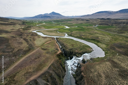 Aerial view of the winding river and Reykjafoss Waterfall in Iceland photo