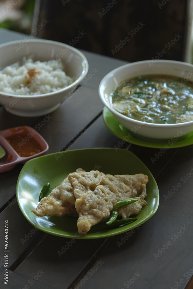 Tempe mendoan , mendoan tempeh or fried tempe on plate. Traditional food from Java, Indonesia. Tempe mendoan , mendoan tempeh or fried tempe on plate. Traditional food from Java, Indonesia.