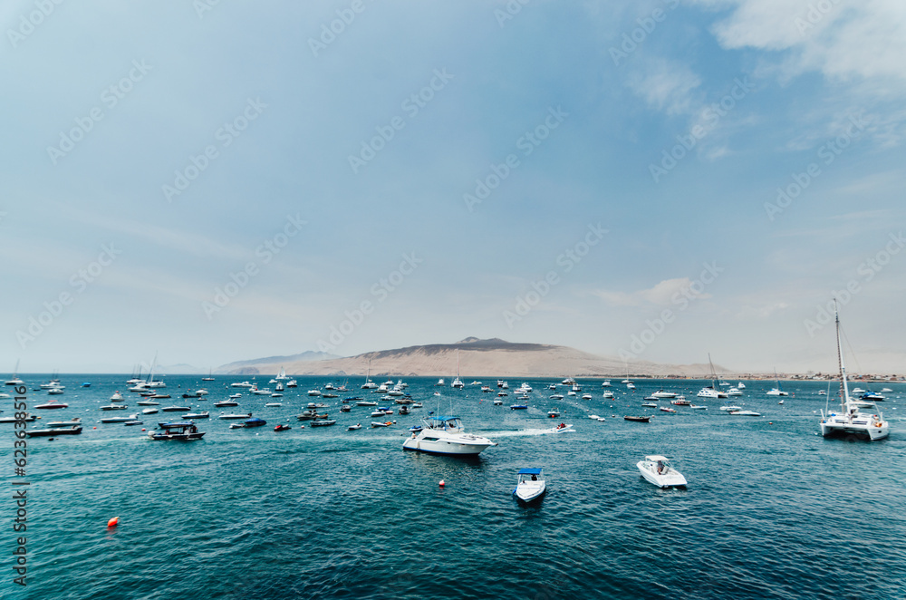 Obraz premium Boats at sea with a mountain in the background. Summer Vacation Concept