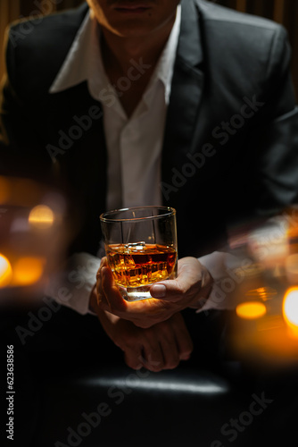 businessmen holding a glass of whiskey
