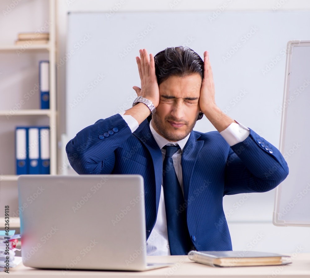 Young handsome businessman working in the office Young handsome businessman working in the office