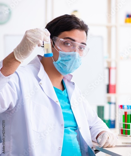 Young male chemist working in the lab