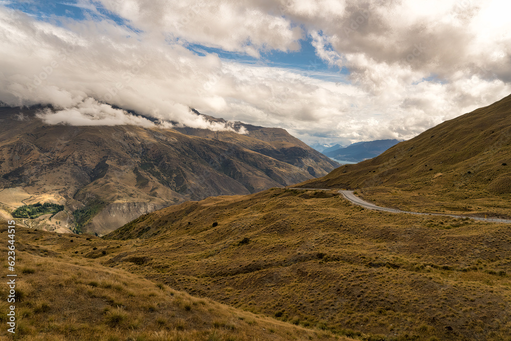 Looking down from the top of the Crown Range road over the agricultural land in the Queenstown valley with the town in the distance Looking down from the top of the Crown Range road over the agricultural land in the Queenstown valley with the town in the distance