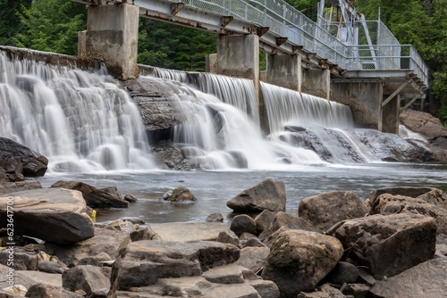 The top section of Wilson s Falls just outside of Bracebridge  Ontario flows beneath a small footbridge.