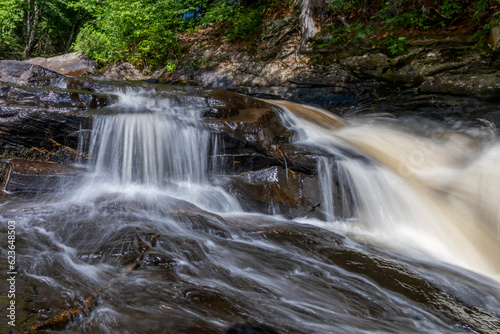 Fototapeta Naklejka Na Ścianę i Meble -  Stubb's Falls in Arrowhead Provincial Park near Huntsville, Ontario flows over some rocks through the forest, and marks the turnaround point of the hiking trail.