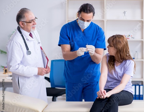 Two doctors examining young woman