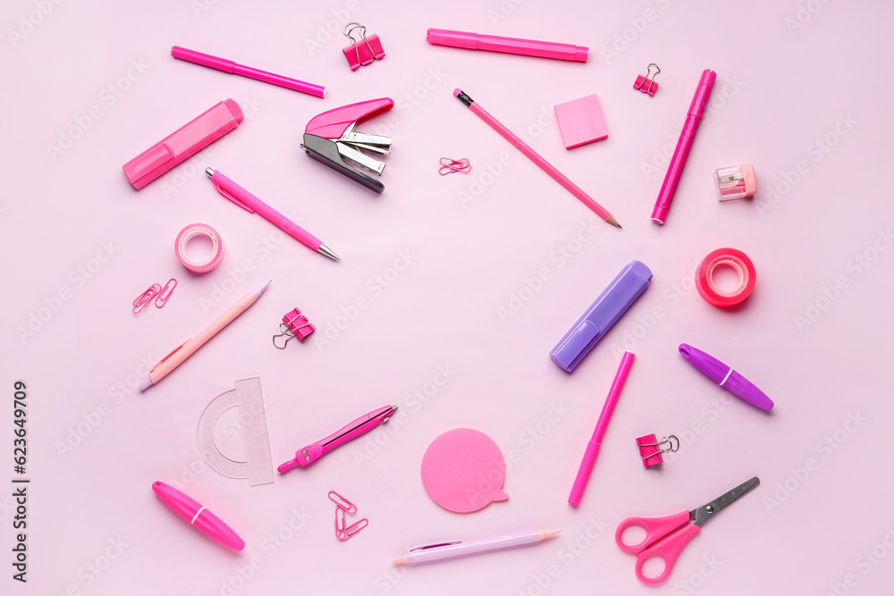 Frame made of stationery supplies on pink background Frame made of stationery supplies on pink background