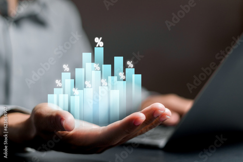 Businessman holding increasing percentage symbol on virtual screen, interest rates and dividends, returns on stocks and mutual funds. long term investment for retirement.