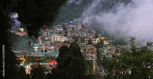 panoramic view of misty and cloudy darjeeling hill station and himalaya mountain foothills in monsoon season, west bengal in india