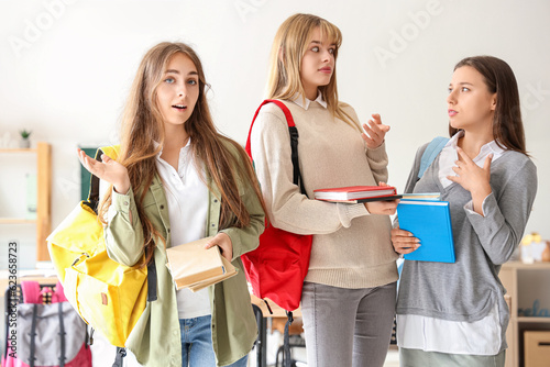 diverse students talking in classroom, education and friendship concept, youn...
