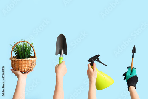 Women with gardening tools and grass on blue background