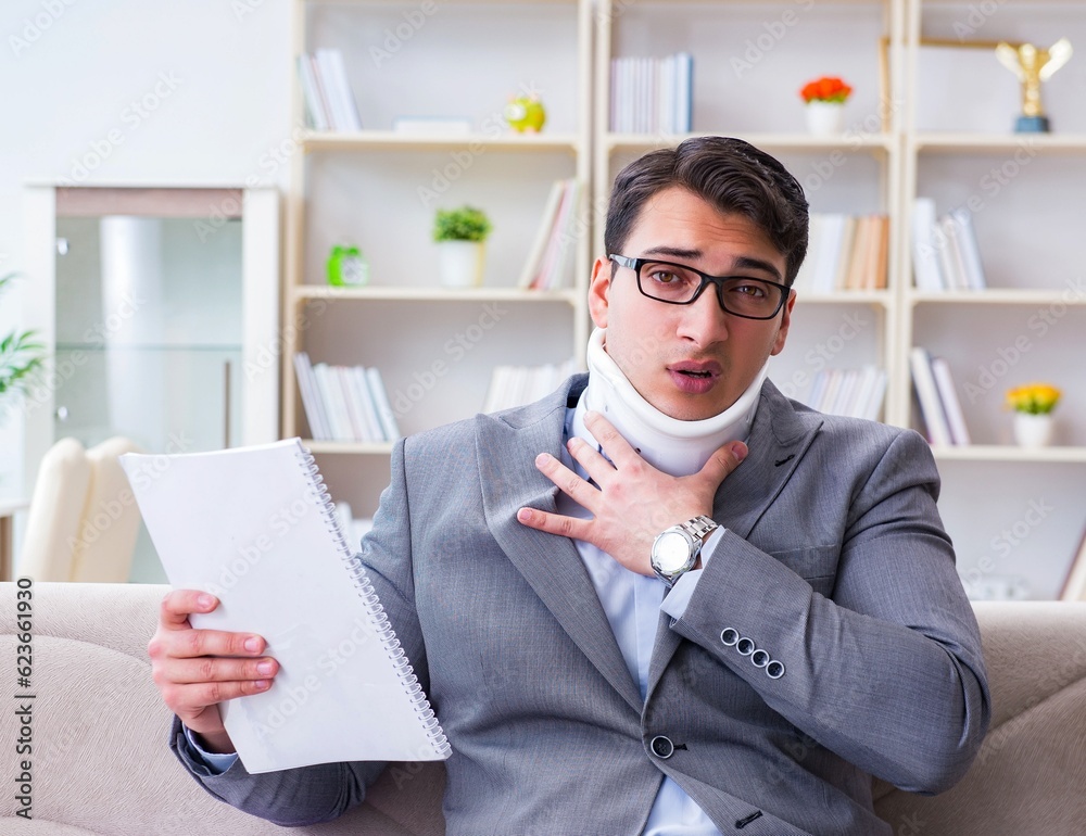 Man in neck brace cervical collar working from home teleworking Man in neck brace cervical collar working from home teleworking