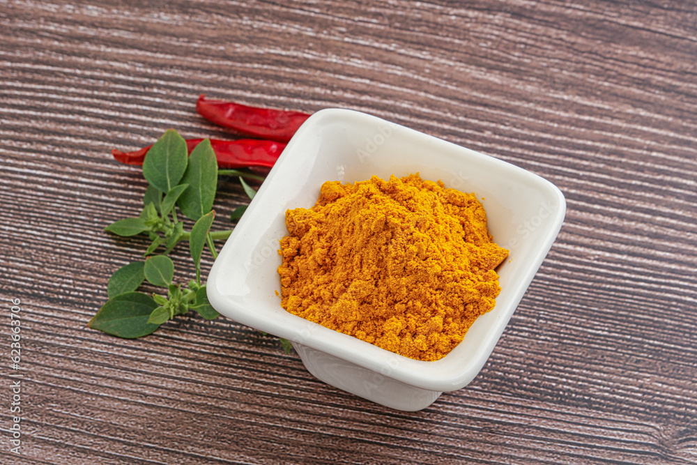 Yellow vibrant curcuma powder in the bowl Yellow vibrant curcuma powder in the bowl