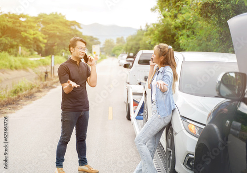 Drivers stood arguing after the car crashed with insurance company officer checking car damages on country road.