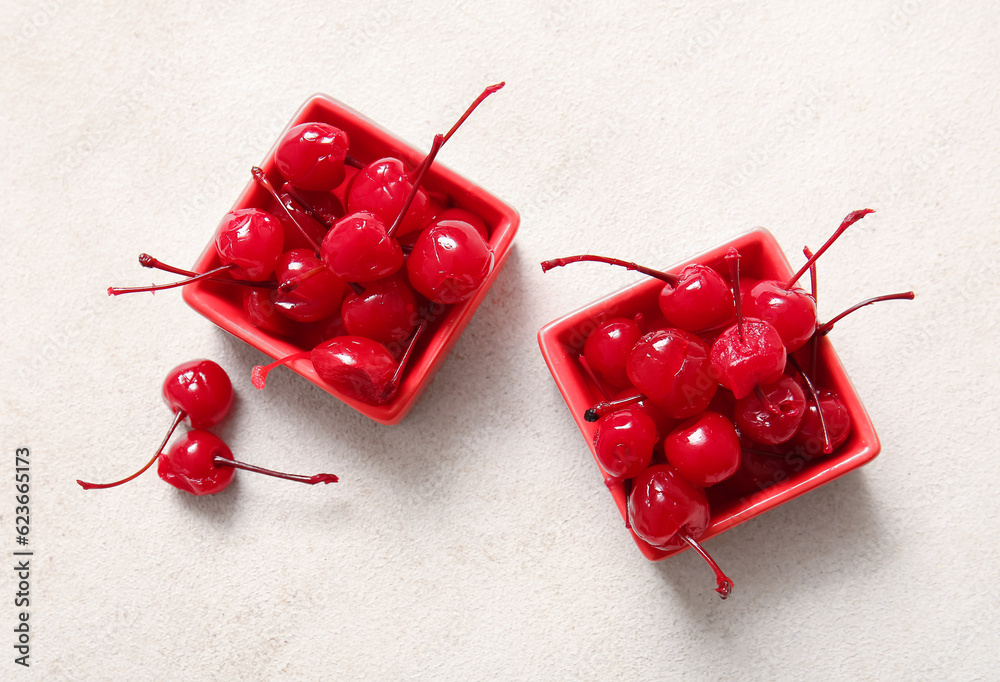 Bowls of tasty maraschino cherries on light background - obrazy, fototapety, plakaty 