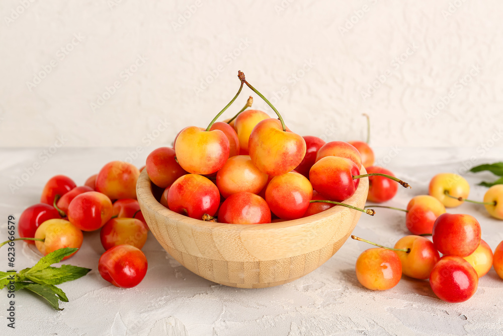 Bowl with sweet yellow cherries on white background Bowl with sweet yellow cherries on white background