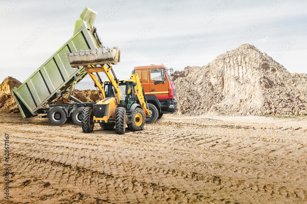 Obraz premium Modern construction machinery at a construction site in a quarry. Powerful modern equipment for earthworks. Rental of construction equipment. Excavator, dump truck, bulldozer, loader.