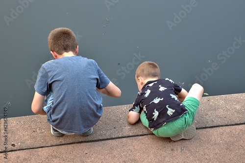 boys looking into water