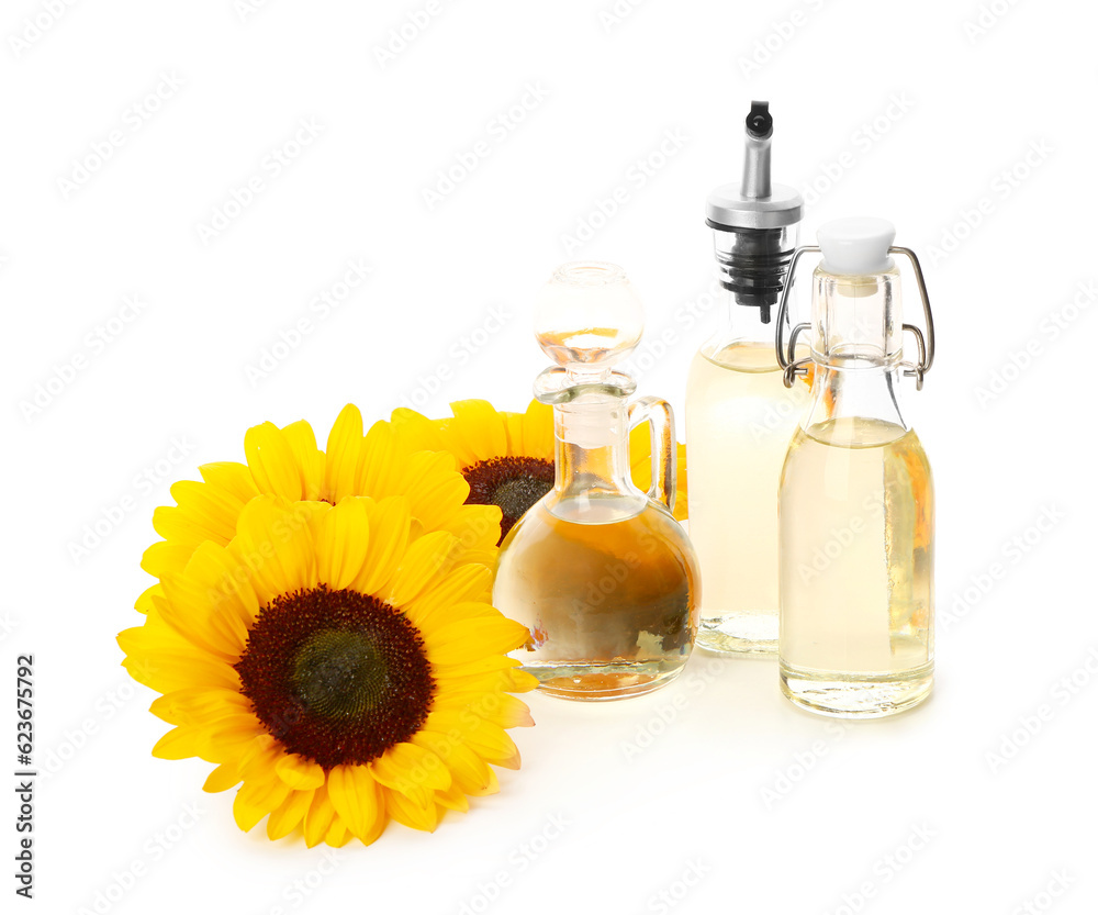 Bottles and decanter with sunflower oil on white background Bottles and decanter with sunflower oil on white background