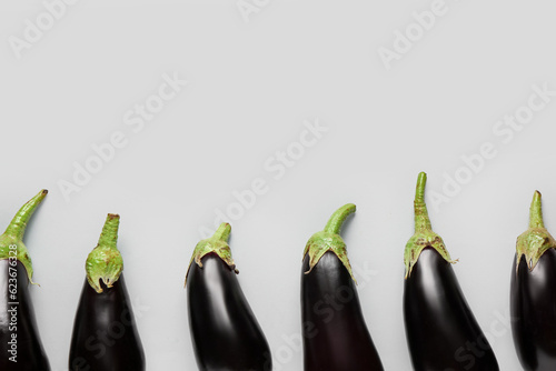 Fresh eggplants on grey background