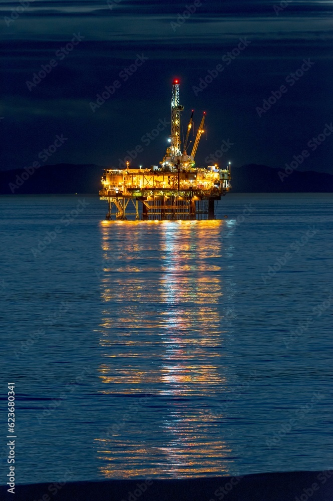 Coastal Convergence: Oil Rig and Surfer at Huntington Beach, California, Harmoniously Uniting on Film in 4K Resolution Coastal Convergence: Oil Rig and Surfer at Huntington Beach, California, Harmoniously Uniting on Film in 4K Resolution