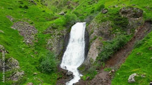 Arsha waterfall in green mountain kazbegi, view from flying drone - stock video georgia photo