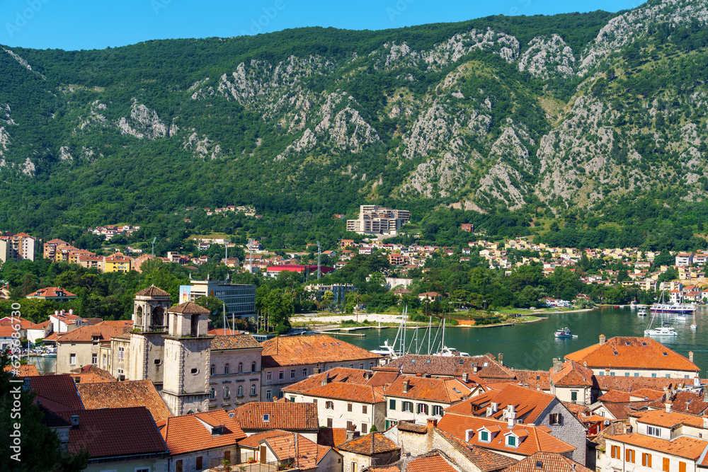 view of the old town of Kotor in Montenegro and the coast of the Bay of Kotor, the sea and medieval European architecture, city streets, red tiled roofs, the concept of traveling across the Balkans