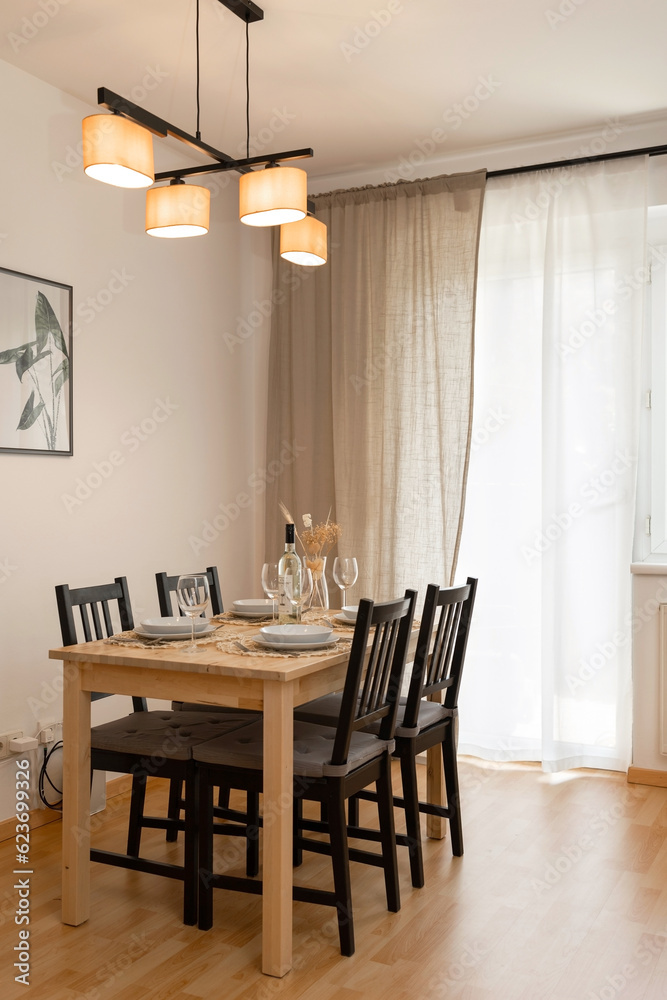Dining table and chairs in the room. The interior of the apartment. Dining table and chairs in the room. The interior of the apartment.