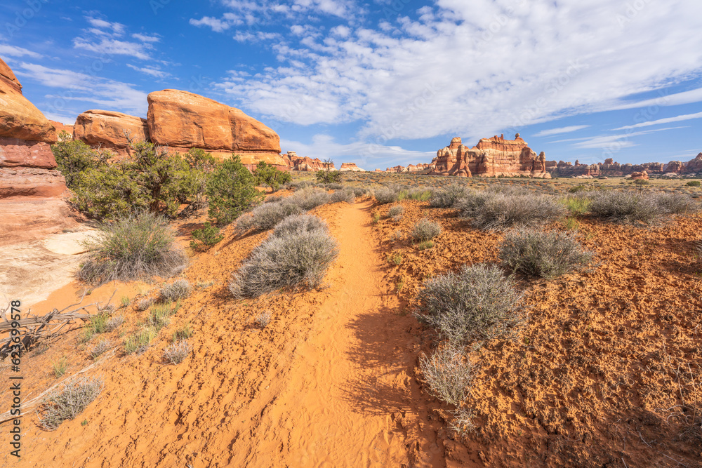 hiking the chesler park loop trail in the needles in canyonlands national park, usa hiking the chesler park loop trail in the needles in canyonlands national park, usa