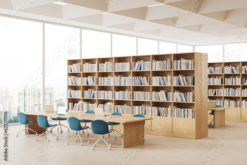 Photography Cozy library interior with bookshelves and desk with laptop, window