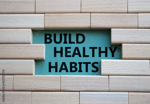 Healthy habits symbol. Concept word Build Healthy habits on wooden blocks. Beautiful grey green background. Healthy lifestyle and Healthy habits concept. Copy space