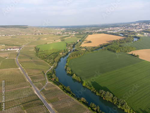 Panoramic aerial view on green premier cru champagne vineyards and fields near village Hautvillers and Cumieres and Marne river valley, Champange, France