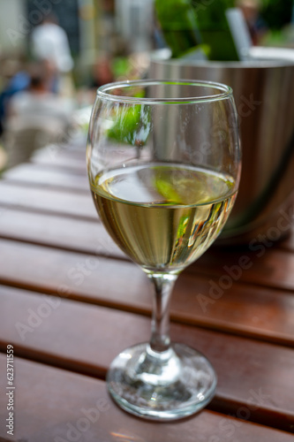 Drinking cold white wine on outdoor terrace, summer vacation, close up