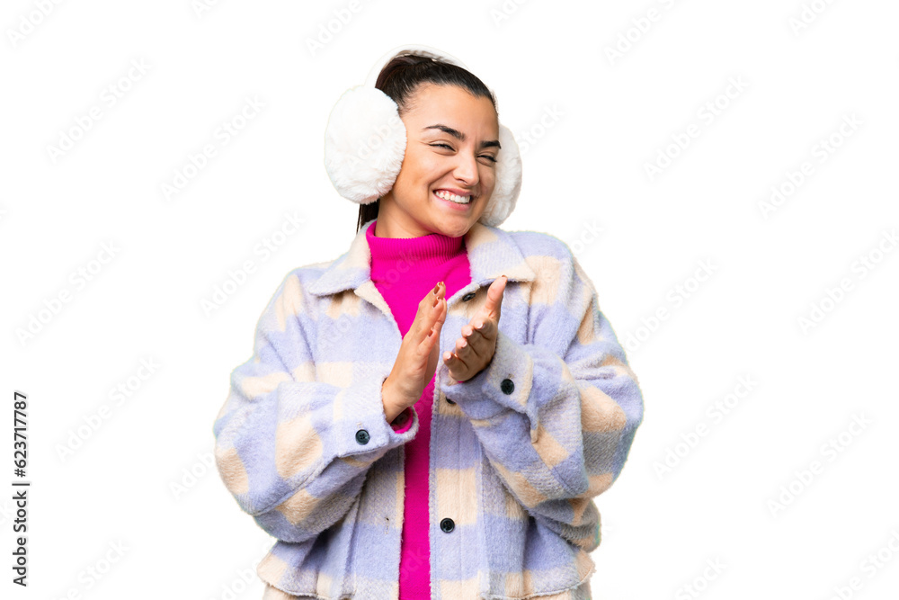 Young woman wearing winter muffs over isolated chroma key background applauding after presentation in a conference Young woman wearing winter muffs over isolated chroma key background applauding after presentation in a conference