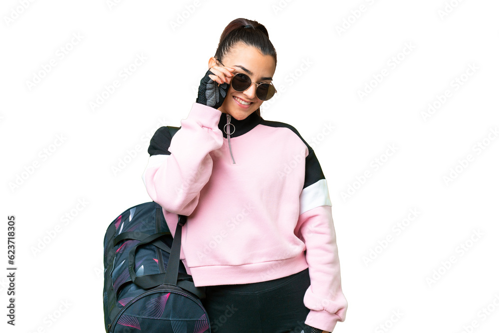 Young sport woman with sport bag over isolated chroma key background with glasses and happy Young sport woman with sport bag over isolated chroma key background with glasses and happy
