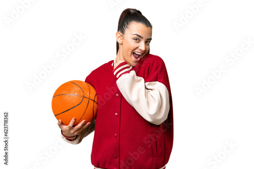 Young Woman playing basketball over isolated chroma key background celebrating a victory © luismolinero