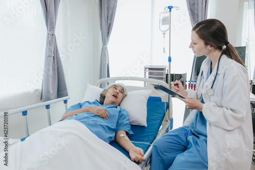 professional female doctor treating elderly patients on hospital beds
