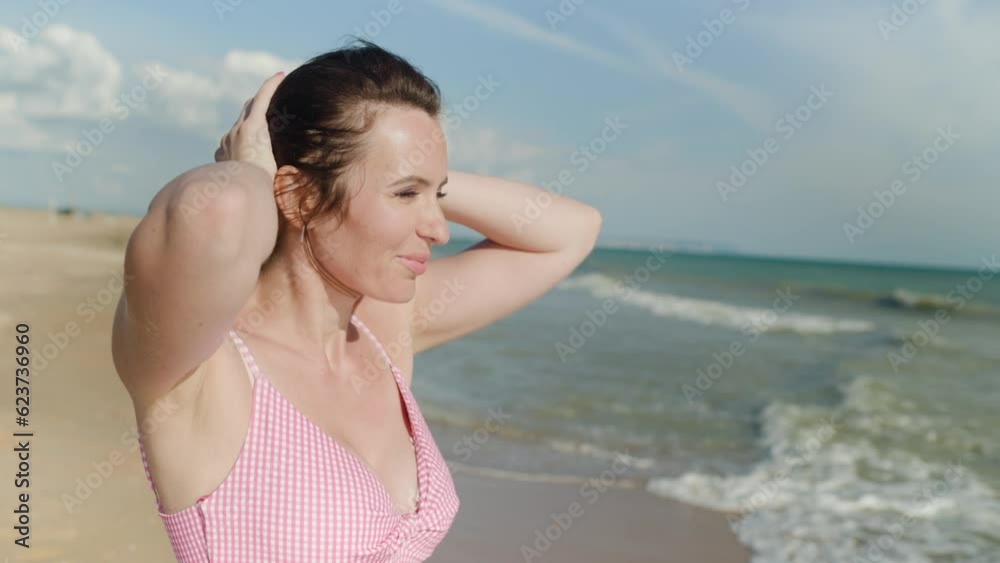 Beautiful adult brunette woman on a sandy seashore Beautiful adult brunette woman on a sandy seashore