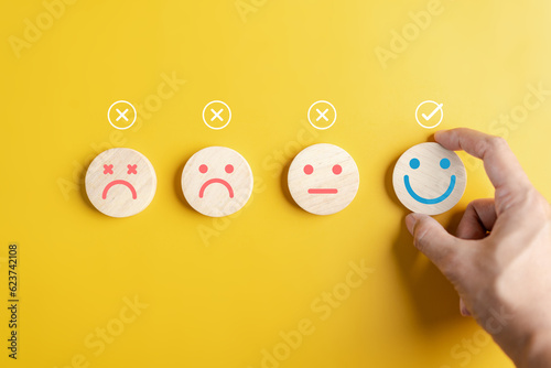 Hands choose happy smile face. mental health positive thinking and growth mindset concept...