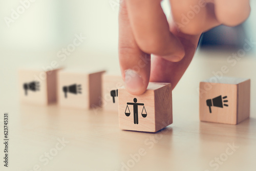 Ethical marketing and communication concept. Using responsible communication and practices that respect the interests of stakeholders. Wooden cube blocks with ethics and marketing communication icons. photo