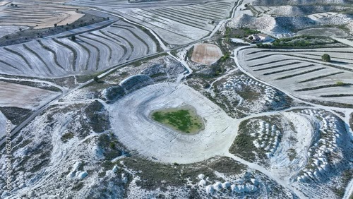 Water pond in the desert landscape of boulevards, erosions and crops of the Los Monegros region. Saragossa province. Aragon. Spain. Europe photo