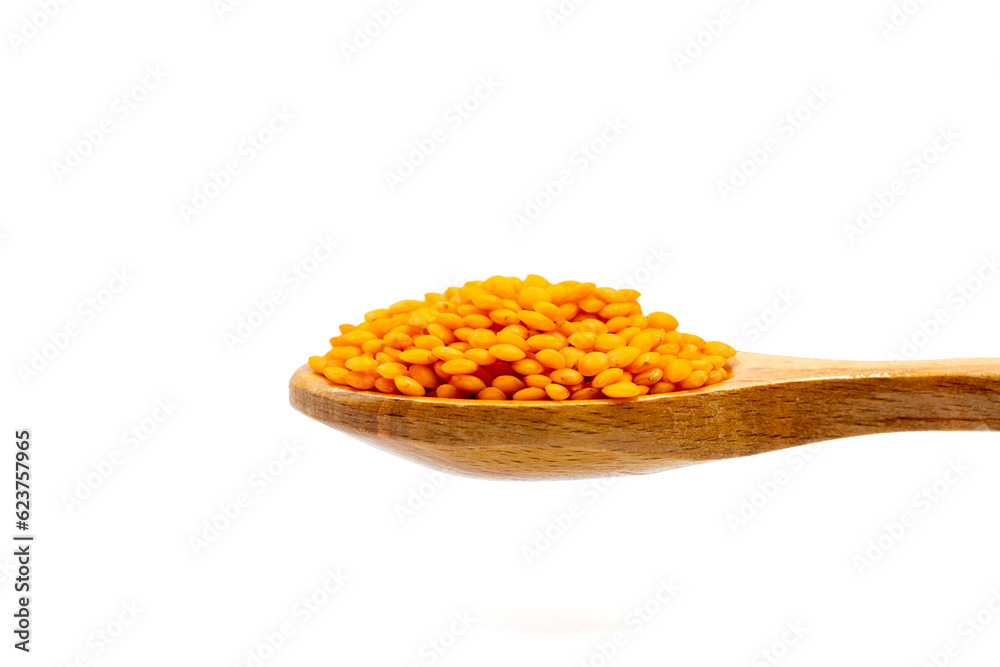 Red lentils on wooden spoon. Pile of Red lentils isolated on white background. close up Red lentils on wooden spoon. Pile of Red lentils isolated on white background. close up