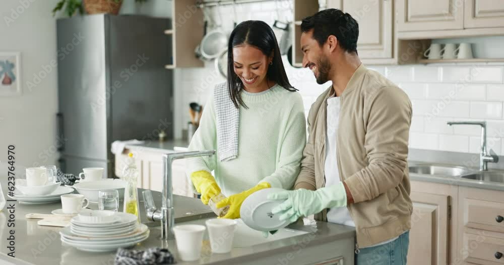 Couple, talking and kitchen sink for washing dishes together, helping hand or happy chat in home with joke. Man, woman and teamwork for bacteria, cleaning or smile for comic conversation in apartment Couple, talking and kitchen sink for washing dishes together, helping hand or happy chat in home with joke. Man, woman and teamwork for bacteria, cleaning or smile for comic conversation in apartment