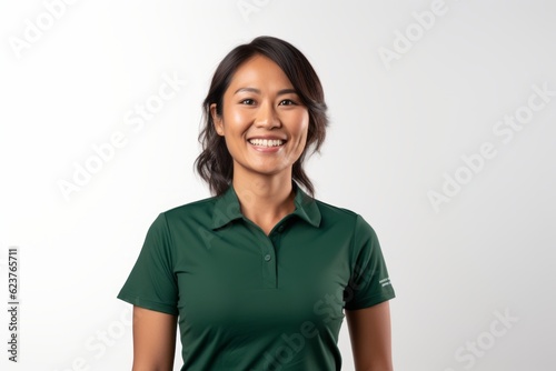 Portrait photography of a pleased Indonesian woman in her 30s wearing a sporty polo shirt against a white background 
