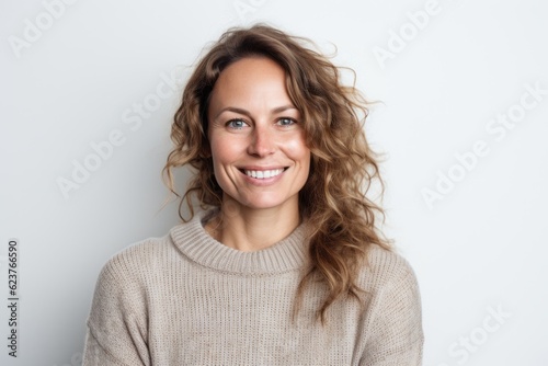 Portrait of a happy young woman with wavy hair on white background