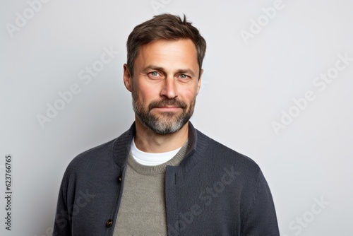 Portrait of a handsome man with a beard on a gray background