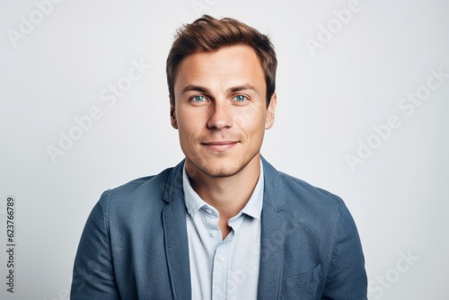 Portrait of a young handsome businessman looking at camera over white background