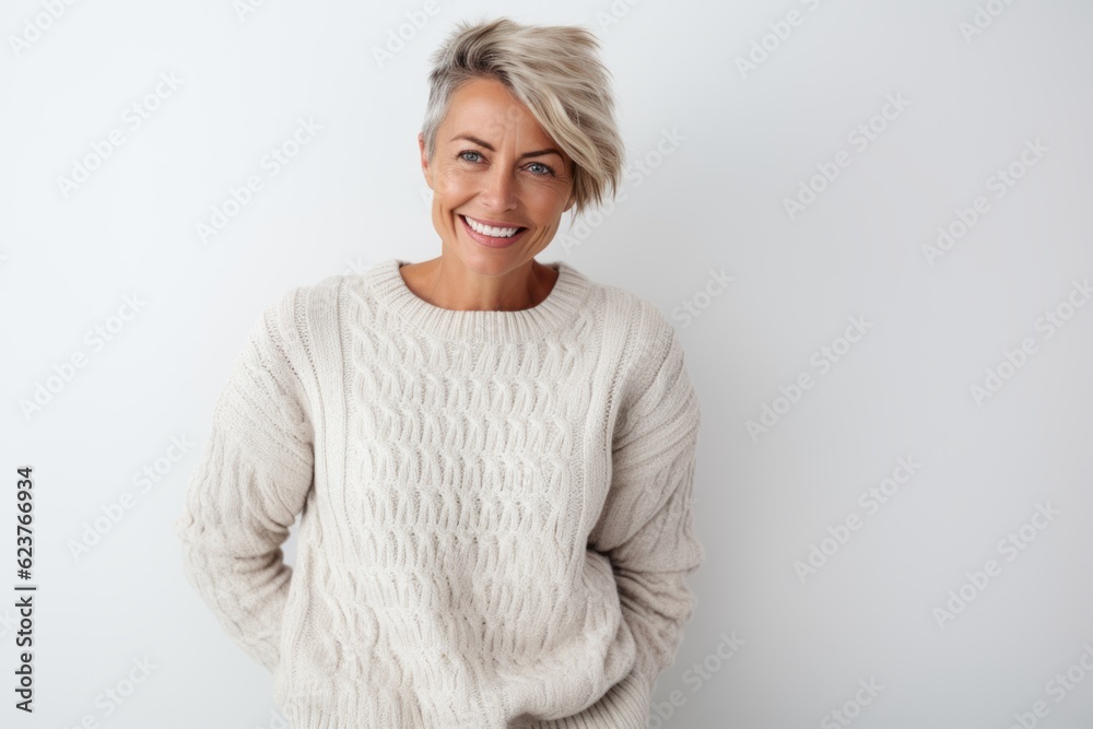 Portrait of happy mature woman standing with arms crossed against white background Portrait of happy mature woman standing with arms crossed against white background