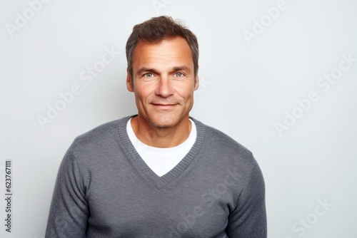 Portrait of a handsome man smiling at the camera against white background