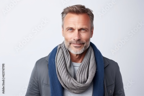 Portrait of handsome mature man with grey scarf looking at camera.